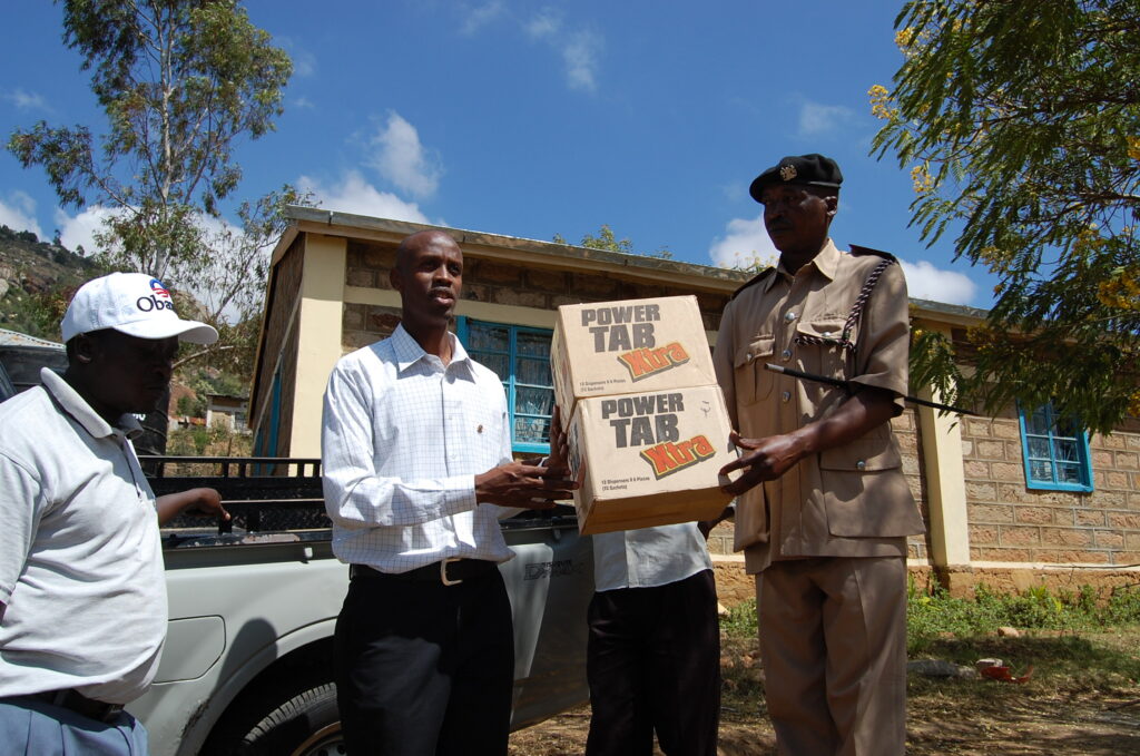 Caleb Mule and Richard Mutunga distribute malarib for bed netting